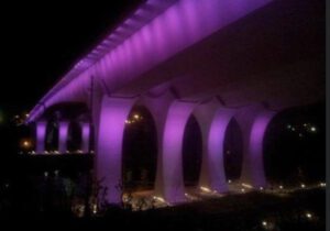 An Underside of a Bridge With Violet Lighting